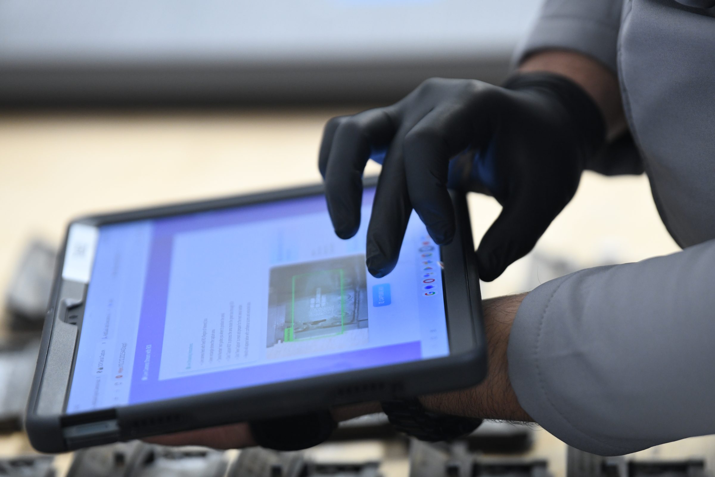 An AddQual operator capturing inspection results into MiDAS on a rugged tablet at the point of measurement.